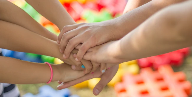 Hands joined together in a gesture of support