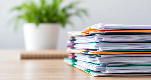 A stack of paper folders and documents